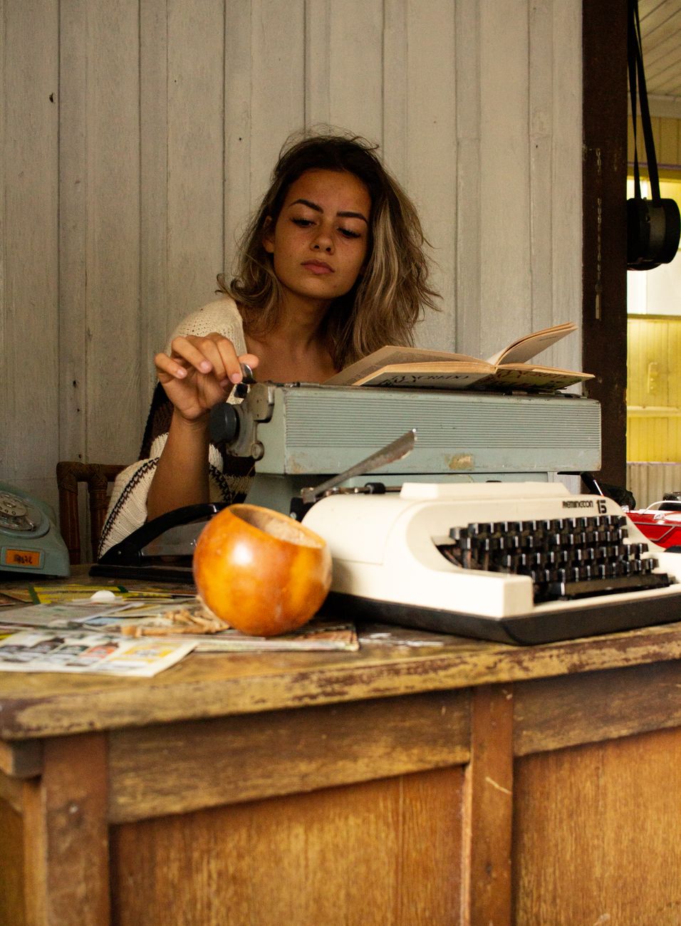 Writer working at rustic desk overlooking valley